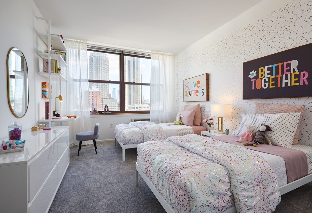 a bedroom with two twin beds and a window