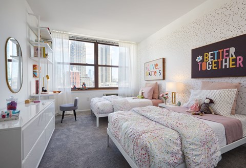 a bedroom with two twin beds and a window