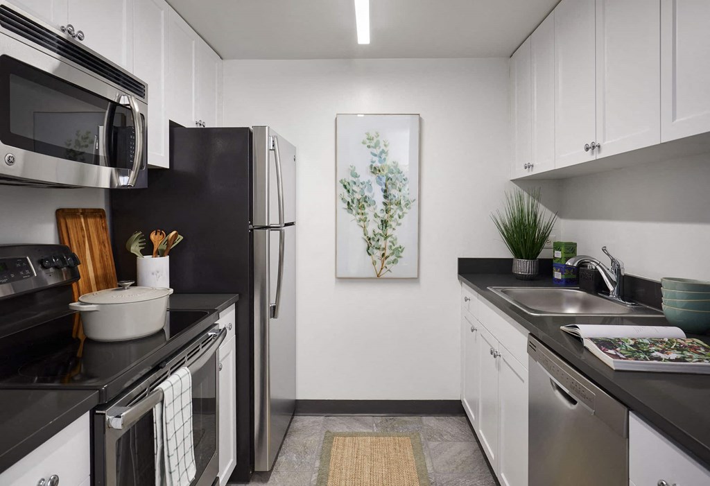 a kitchen with stainless steel appliances and white cabinets