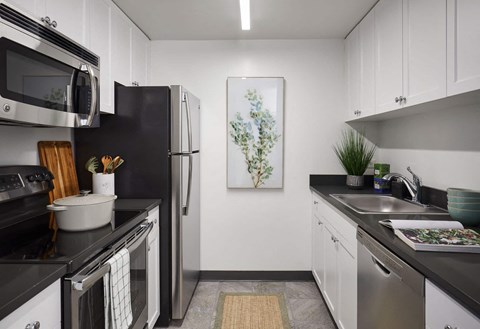a kitchen with stainless steel appliances and white cabinets