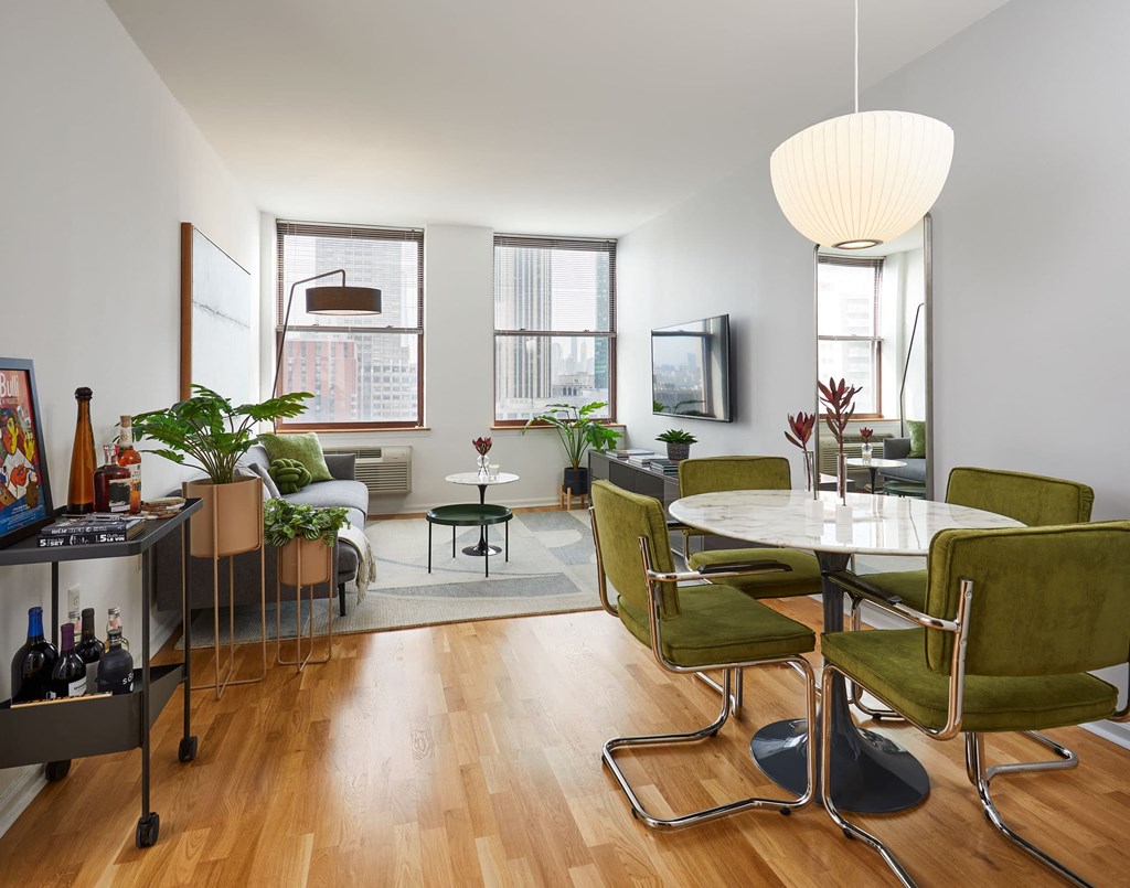 a living room and dining room with a table and chairs