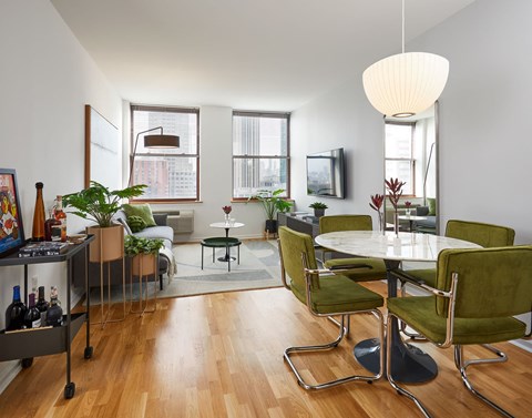 a living room and dining room with a table and chairs