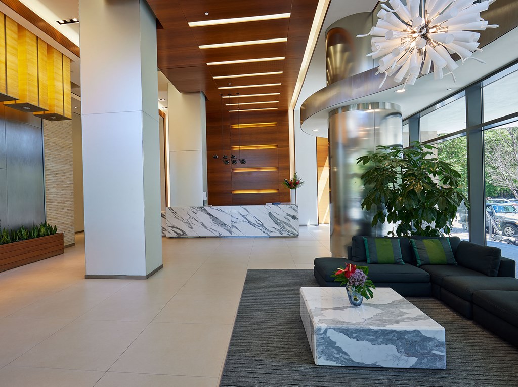 a lobby with couches and a table and a large window