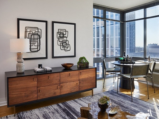 a living room with a table and chairs and a large window