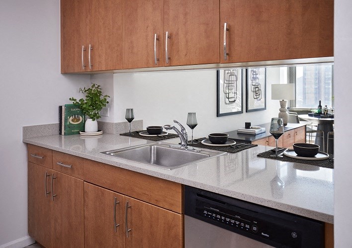a kitchen counter with a sink and a window