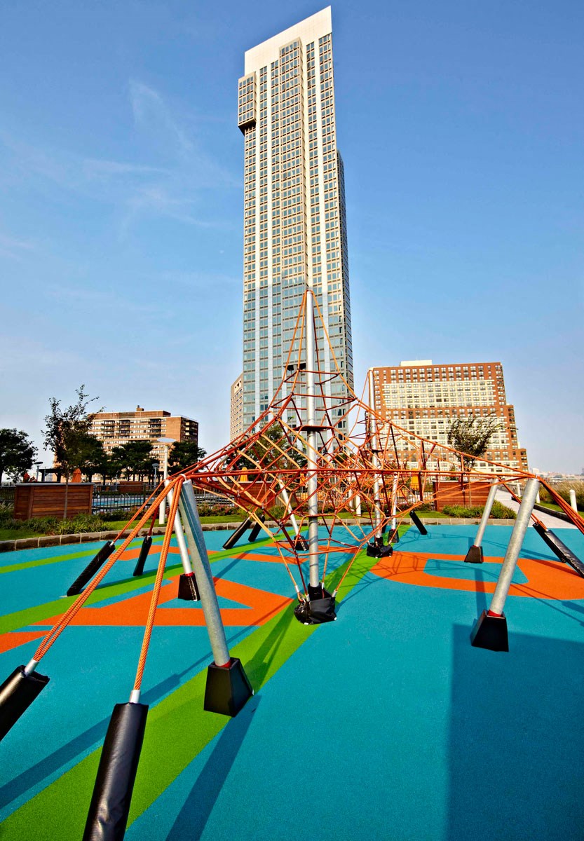 a playground in front of a tall building
