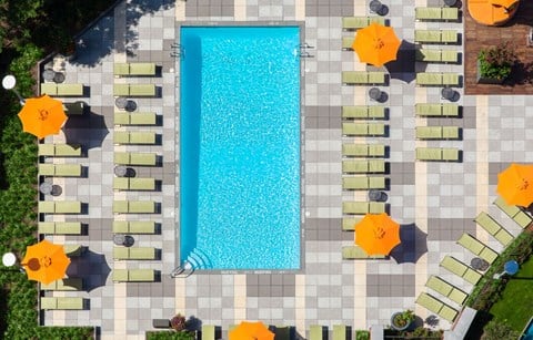 a view of a pool from above with umbrellas