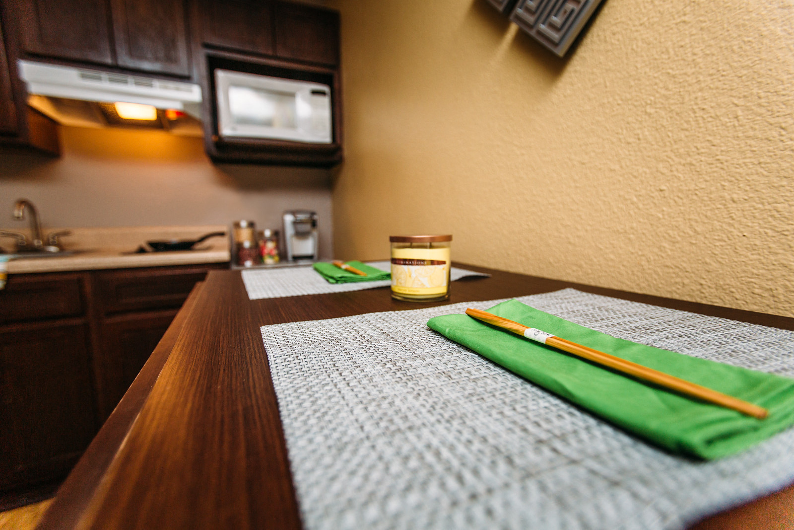 a dining room table with a table cloth and a candle on it