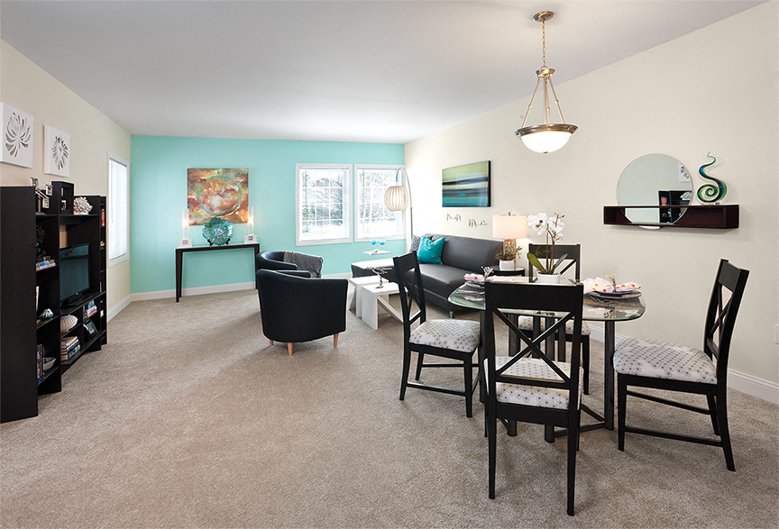 a living room and dining room with a table and chairs