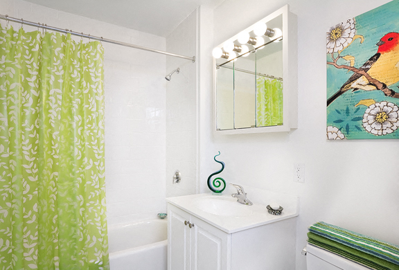 a white bathroom with a shower curtain and a sink