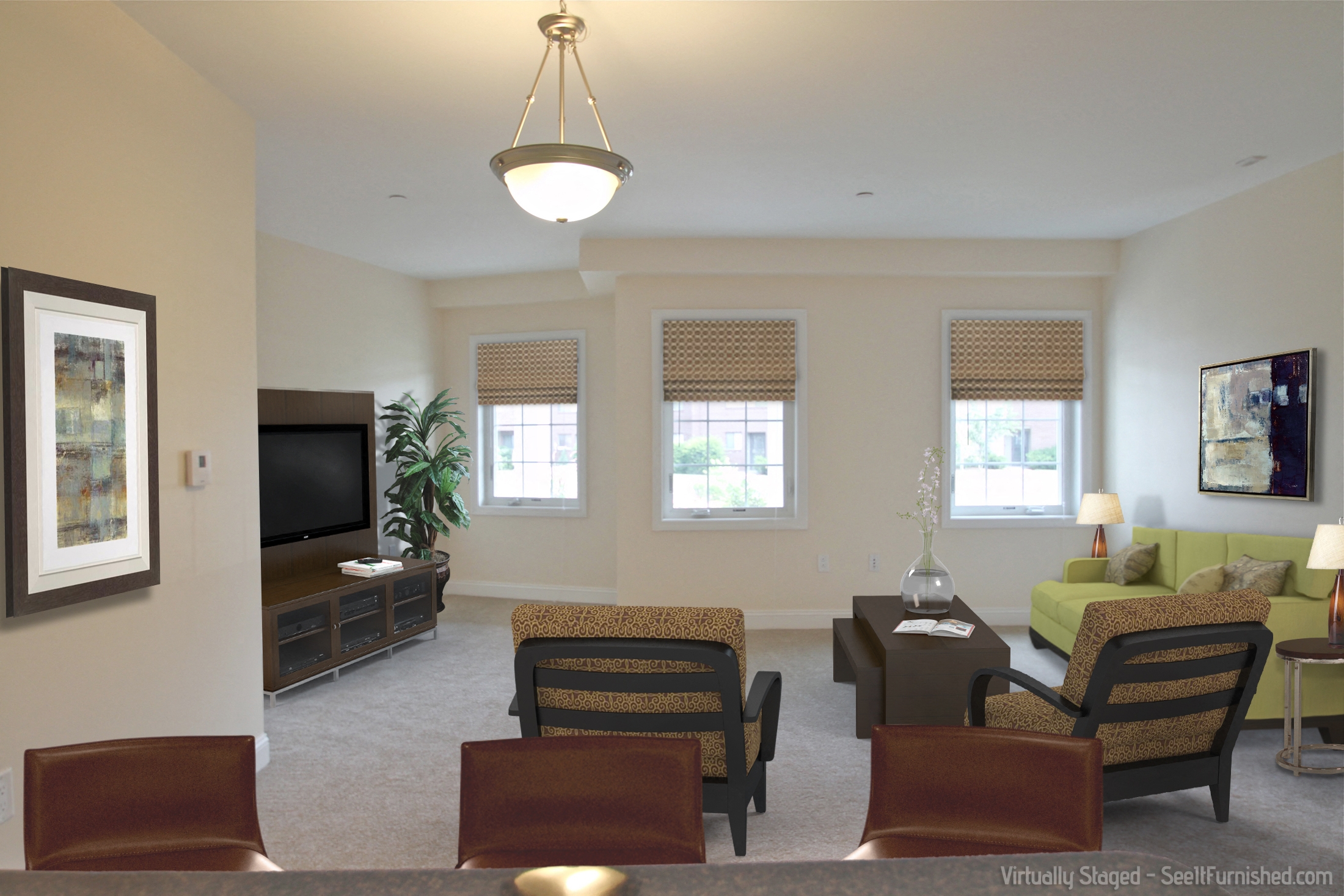 a living room with a couch and chairs and a tv
