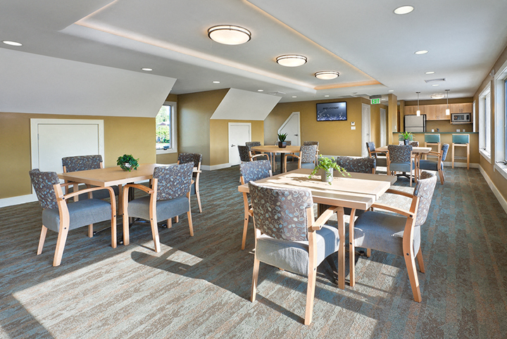 a conference room with tables and chairs and a television