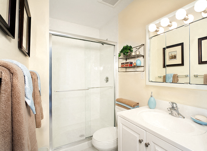 a bathroom with a shower and a sink and a mirror