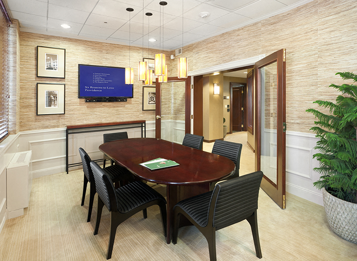 a conference room with a table and chairs