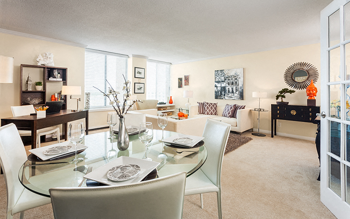 a living room and dining room with a glass table