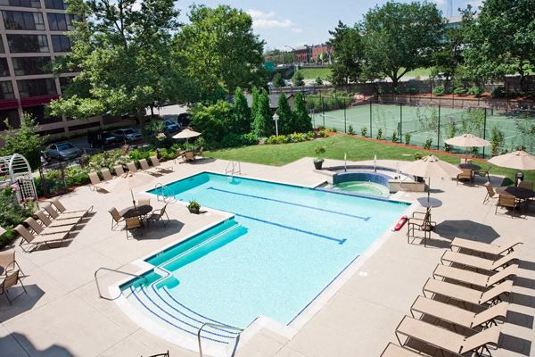 a view of a swimming pool with chairs and umbrellas