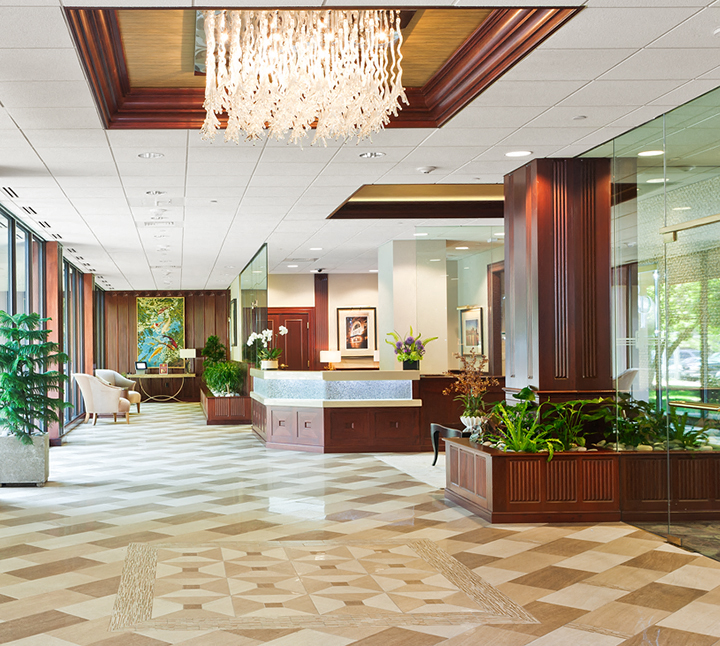a lobby with a reception desk and a chandelier