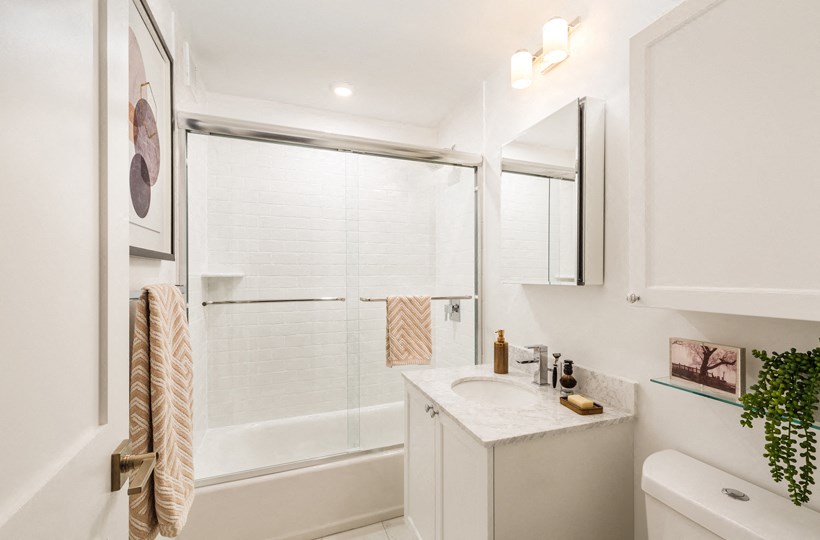 a bathroom with a shower and a sink and a mirror