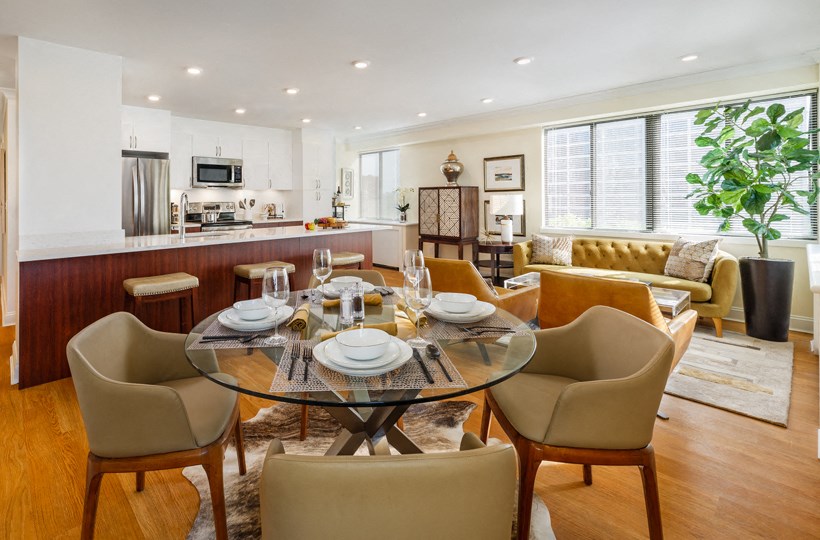 a living room and dining room with a table and chairs