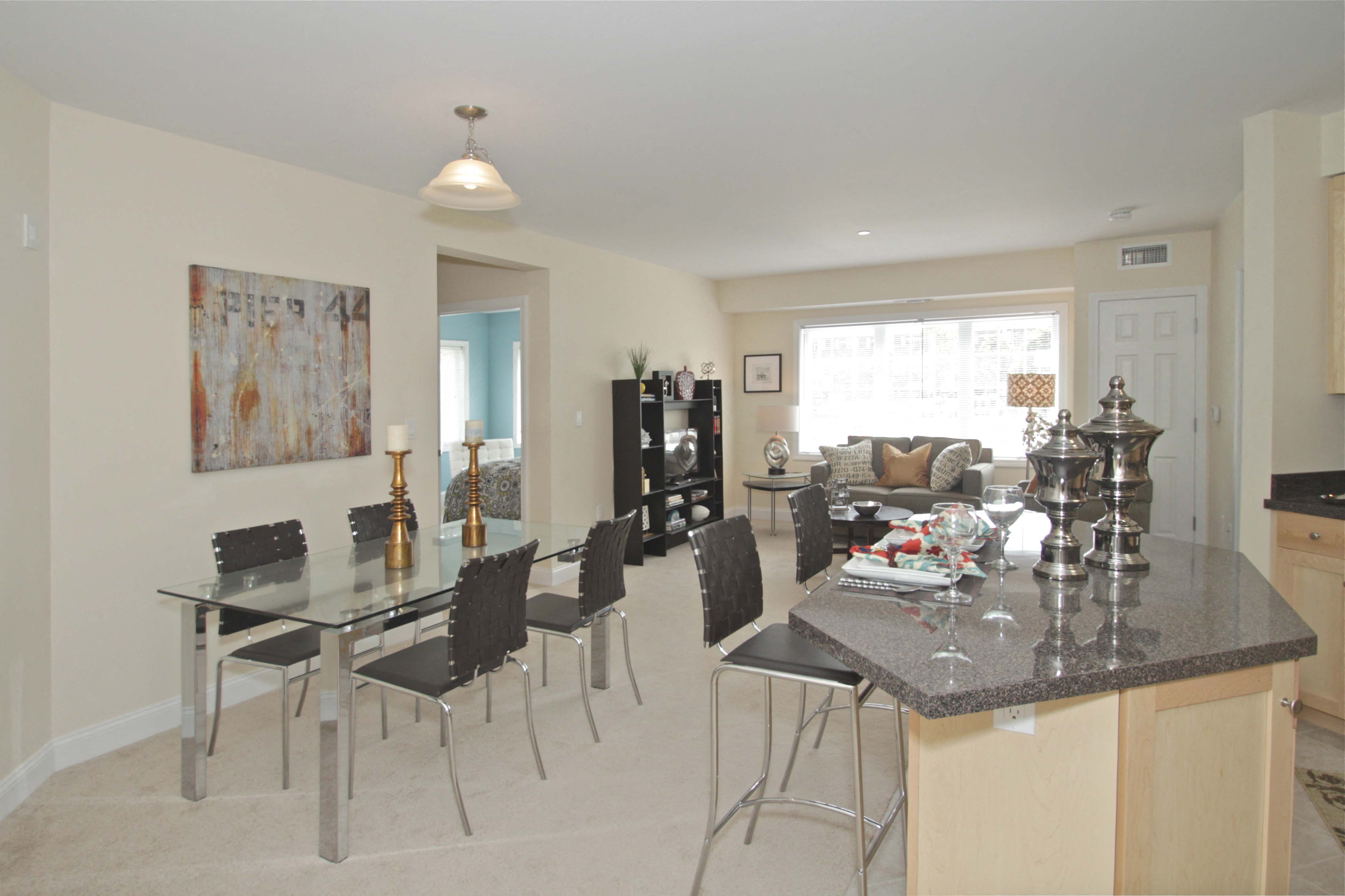 a dining room and living room with a table and chairs