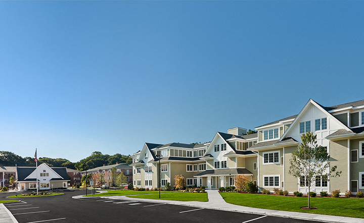 a row of houses on a street with a parking lot