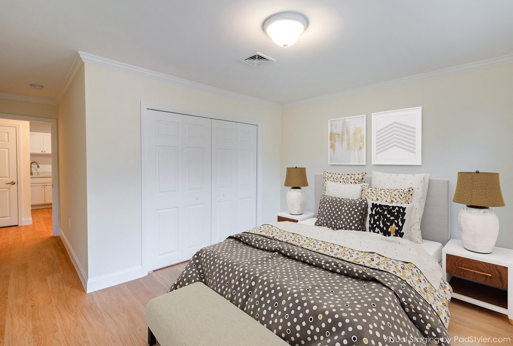 a bedroom with a bed and a white closet