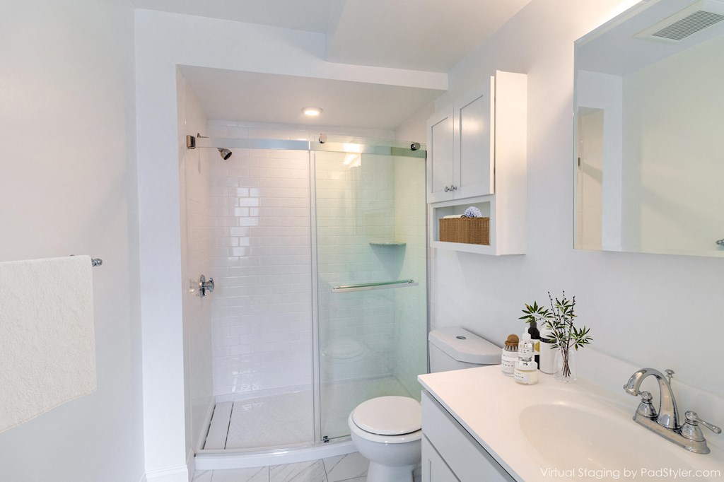 a bathroom with a shower and a sink and a toilet