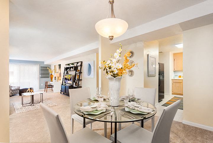 a dining room with a glass table and chairs