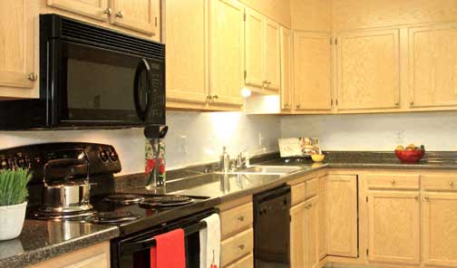 a kitchen with a stove and a sink and a microwave