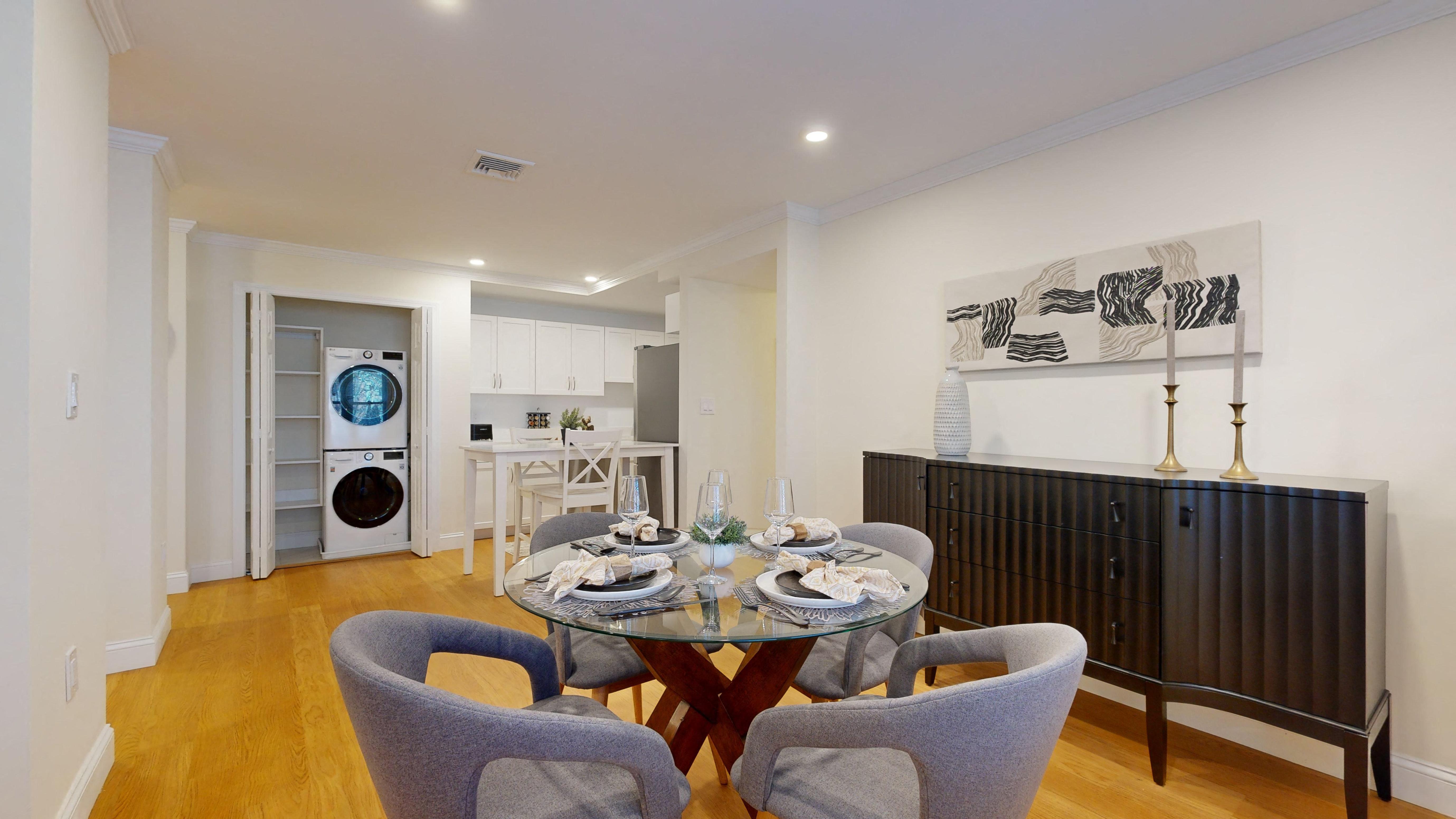 a dining room with a table and chairs and a kitchen
