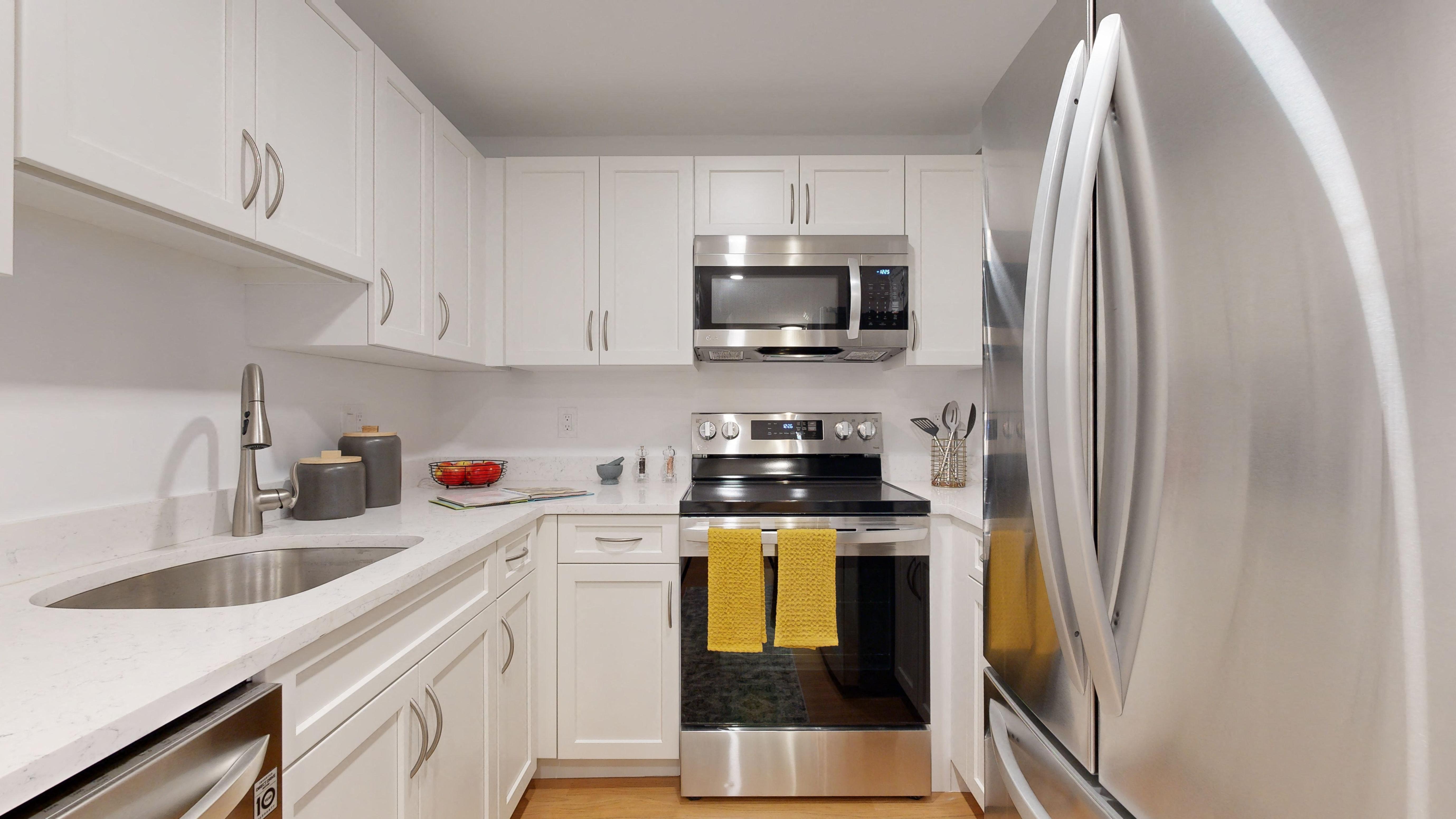 a kitchen with stainless steel appliances and white cabinets