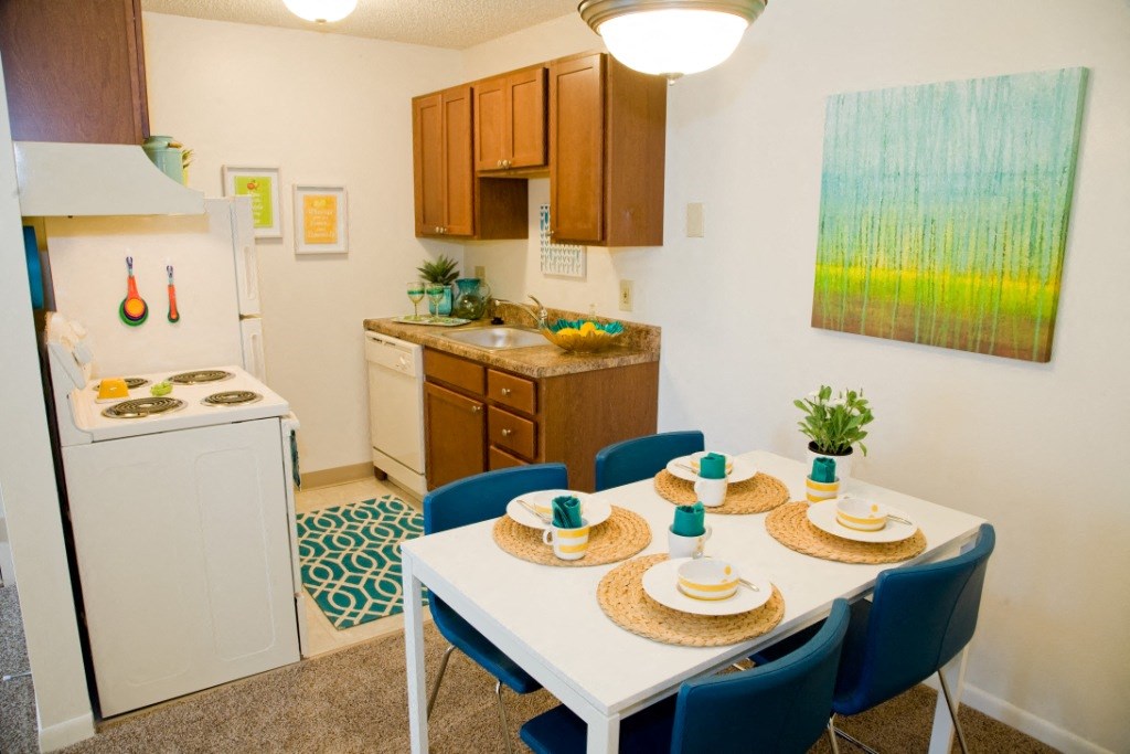 a kitchen and dining area with a table and chairs