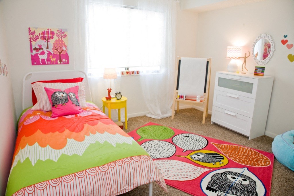 a bedroom with a bed and a dresser and a window