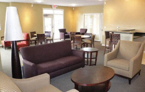 a living room with a couch and chairs and a table