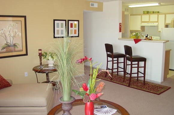 a living room with a couch and a table with flowers