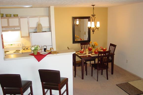 a kitchen and dining room with a table and chairs