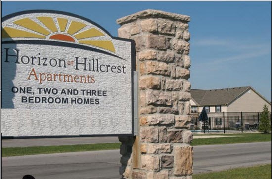 a sign for the apartments on the side of a