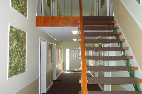 a staircase with a wooden railing in a house