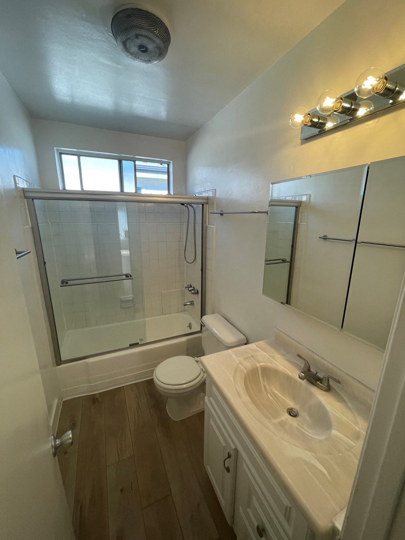 a small bathroom with a sink toilet and shower