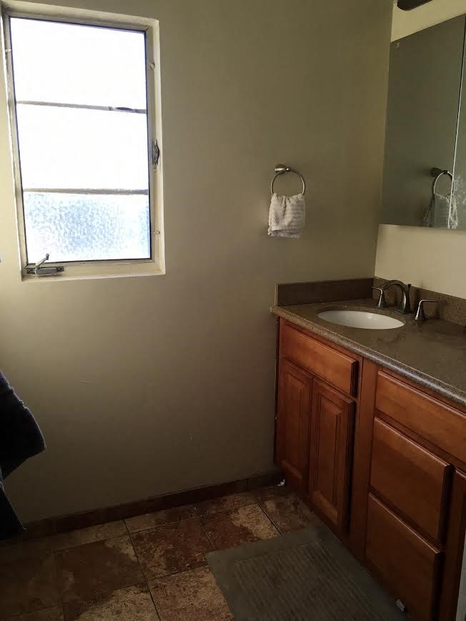 a bathroom with a sink and a window
