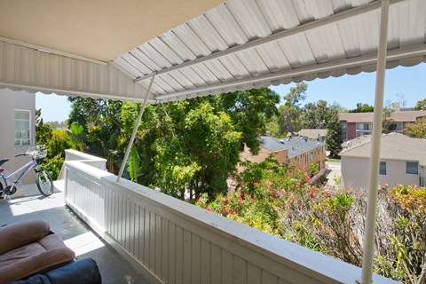 the view from the porch of a house with a white roof