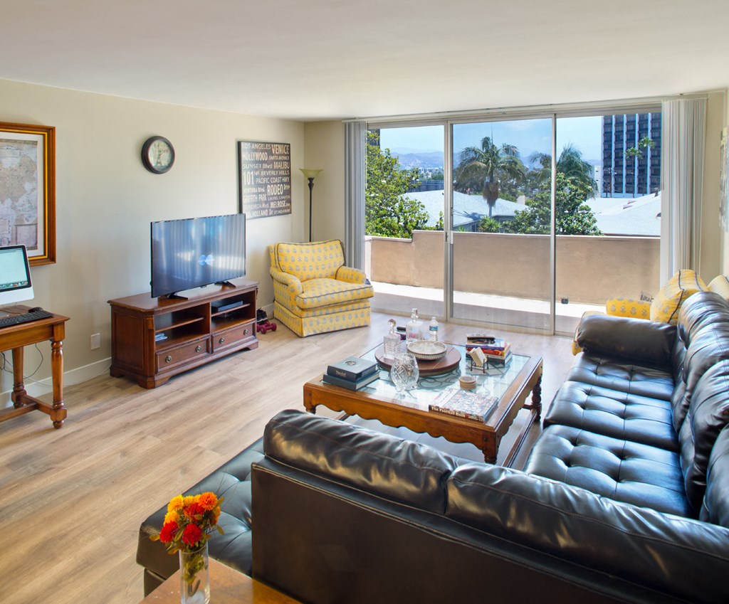 a living room with leather furniture and a large window