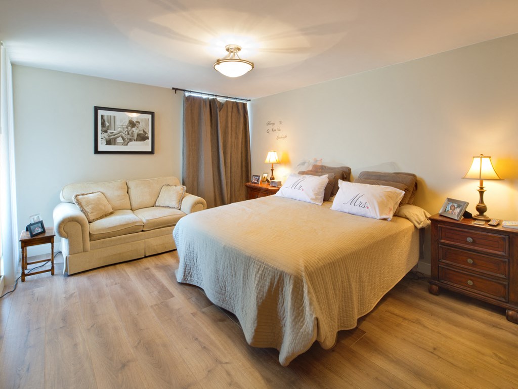 a view of a bedroom with a bed and a couch