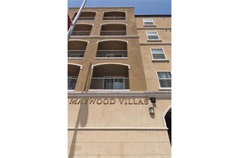 a building with a sign that says maywood villas