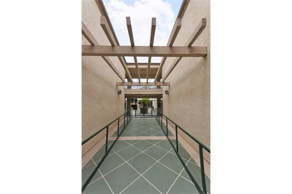 a long walkway with a bridge over it