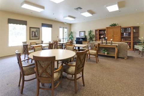 a living room with a round table and chairs