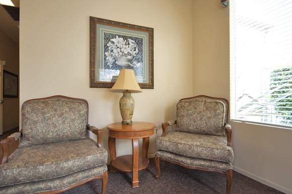 a living room with two chairs and a table