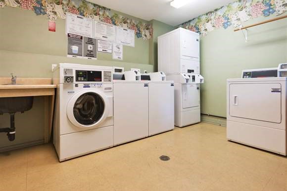 a laundry room with a bunch of washing machines