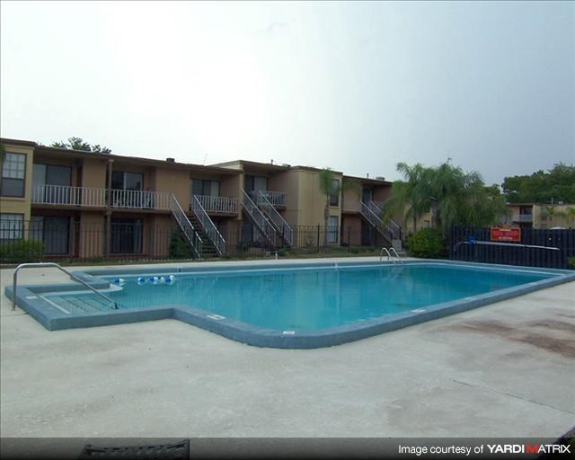 a swimming pool in front of an apartment building