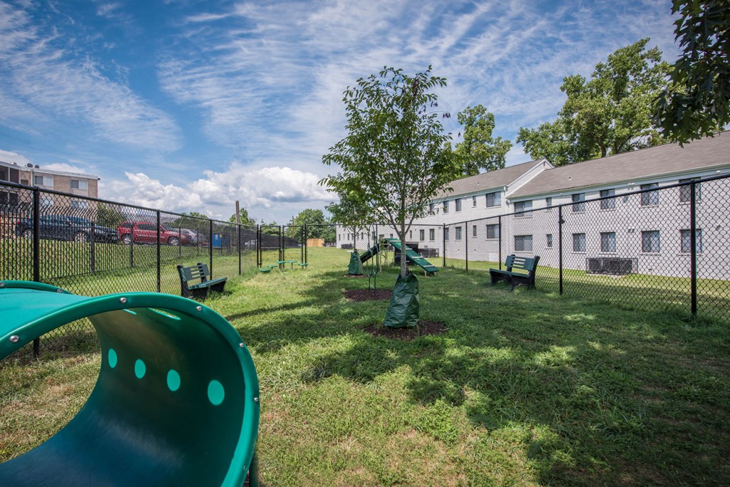 our apartments have a large yard with a playground and benches
